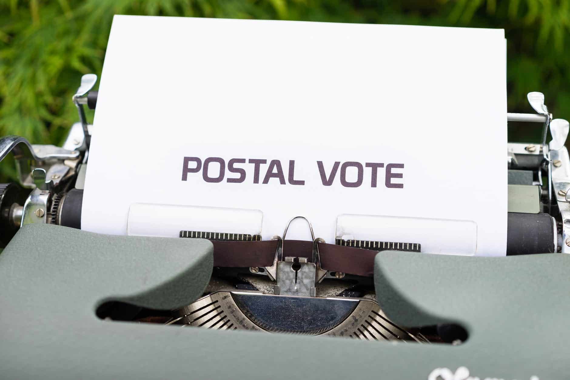paper with the words postal vote in a typewriter